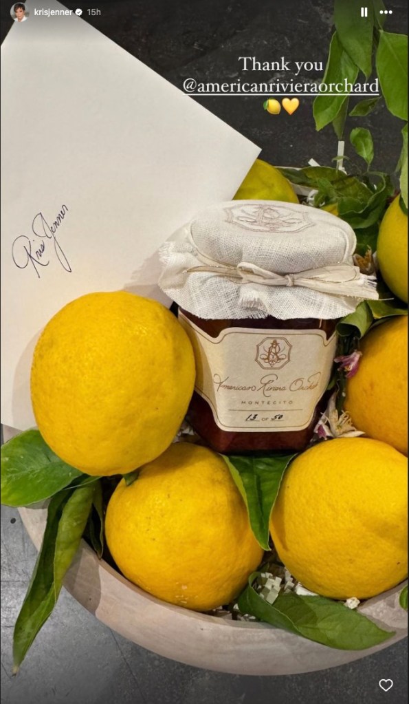 Kris Jenner holding a jar of strawberry jam, a gift from Meghan Markle, on top of lemons