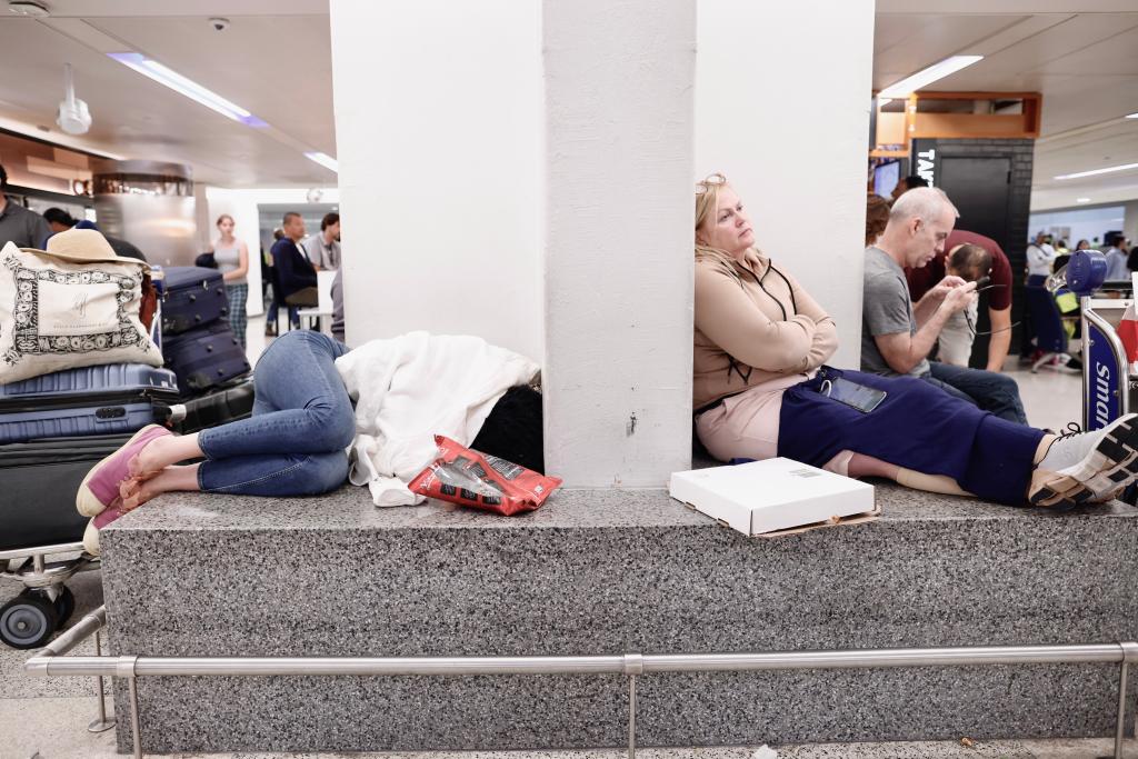 People rest waiting for their flight reschedule inside of the Newark International Airport on June 27, 2023 in Newark, New Jersey.