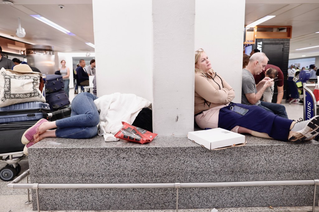 People rest waiting for their flight reschedule inside of the Newark International Airport on June 27, 2023 in Newark, New Jersey.