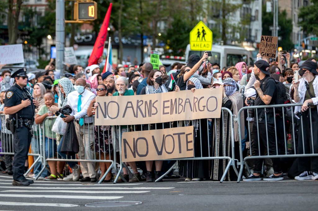 Anti-Israel protesters holding up signs outside the Harris campaign event on Aug. 14, 2024.