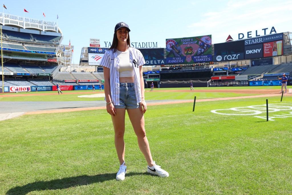 Caitlin Clark on the field before the game when the New York Yankees played the Texas Rangers