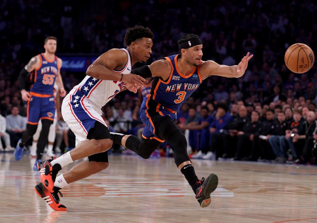 Josh Hart #3 of the New York Knicks and Kyle Lowry #7 of the Philadelphia 76ers chase after the loose ball during the first half at Madison Square Garden on April 30, 2024 in New York City