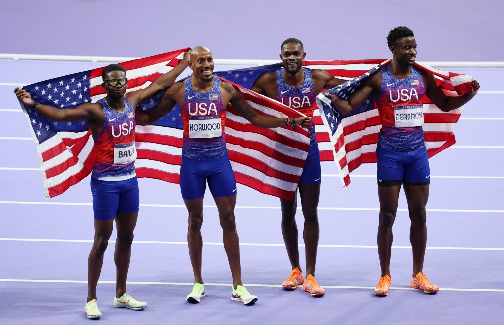 Gold medalists and new Olympic record holders Christopher Bailey, Vernon Norwood, Bryce Deadmon and Rai Benjamin celebrate following the Men's 4x400m Relay Final during the 2024 Olympics. 