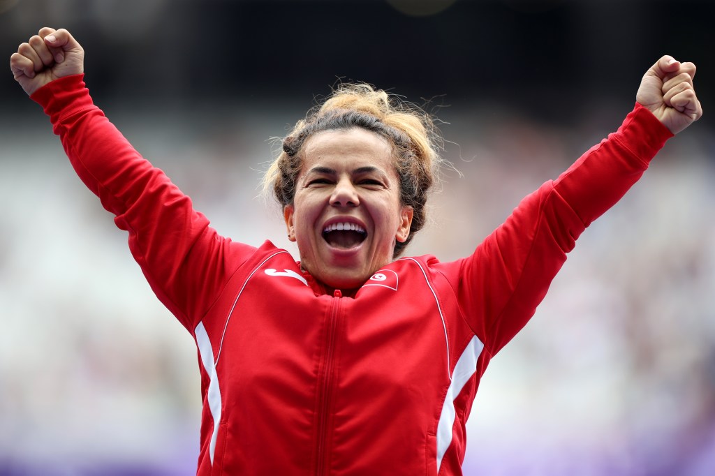 Gold medallist Raoua Tlili of Team Turkey celebrates on the podium during the medal ceremony after the Women's Shot Put F41 final on day two of the Paris 2024 Summer Paralympic Games at Stade de France on August 30, 2024 in Paris, France. 