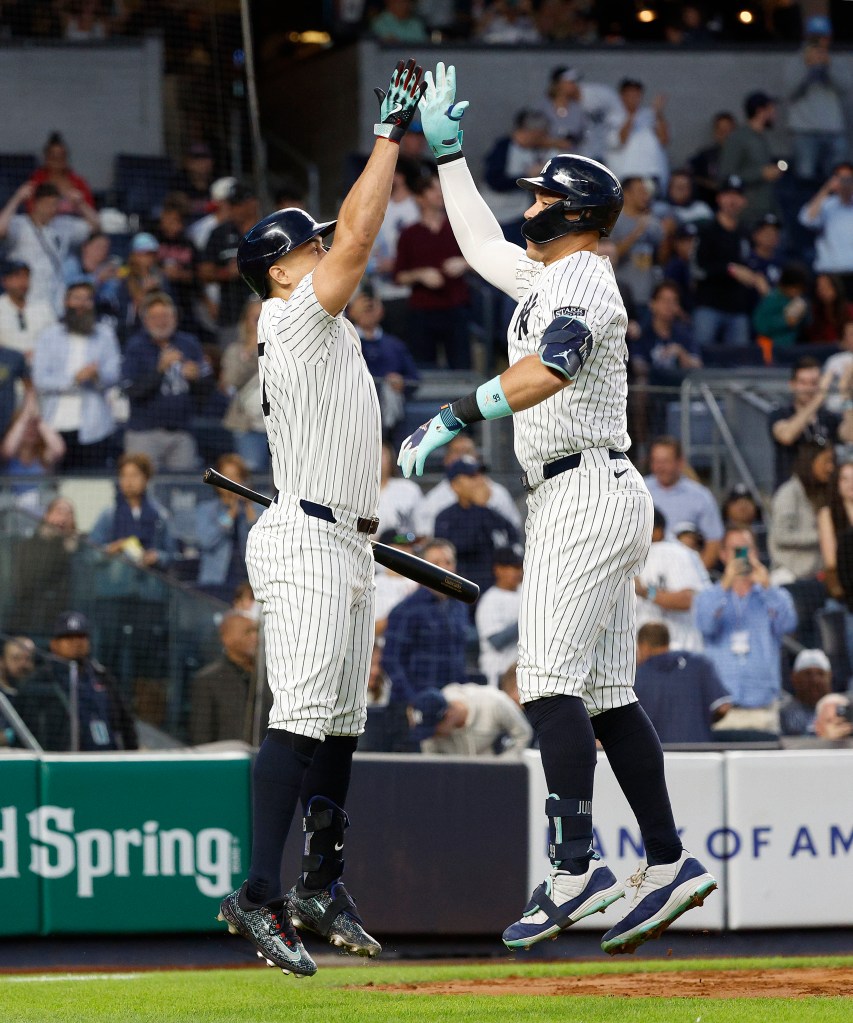 Aaron Judge celebrates with Giancarlo Stanton after he scores on his two-run home run during the third inning.