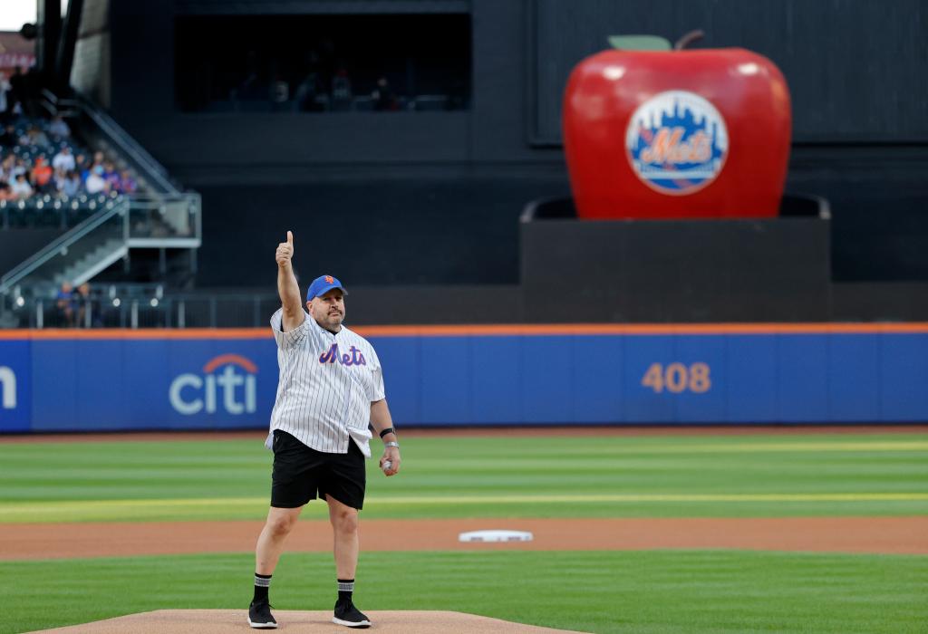 Actor Kevin James waves to the crowd before throwing out the ceremonial first pitch