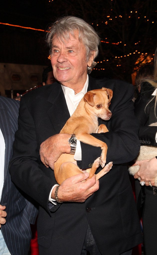 Alain Delon with a dog during the Opening of the Gut Aiderbichl Christmas Market on November 11, 2014 in Henndorf am Wallersee, Austria.