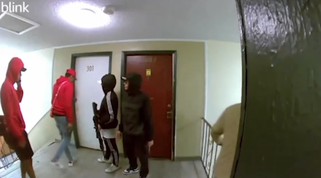 A shocking video shows a crew of gun-wielding men storm through a Colorado apartment building reportedly overrun by a dangerous Venezuelan prison gang. 