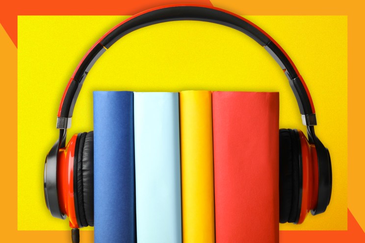 A pair of headphones resting atop a stack of books