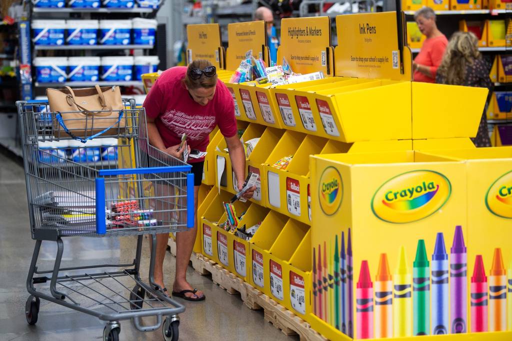 Customers browsing school supplies for sale at a Walmart in Turkey Creek.