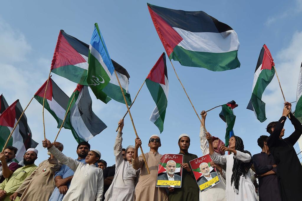 Supporters of the Islamic political party Jamat-e-Islami holding flags during a protest in Karachi, Pakistan, following the death of Hamas political leader Ismail Haniyeh, on July 31.