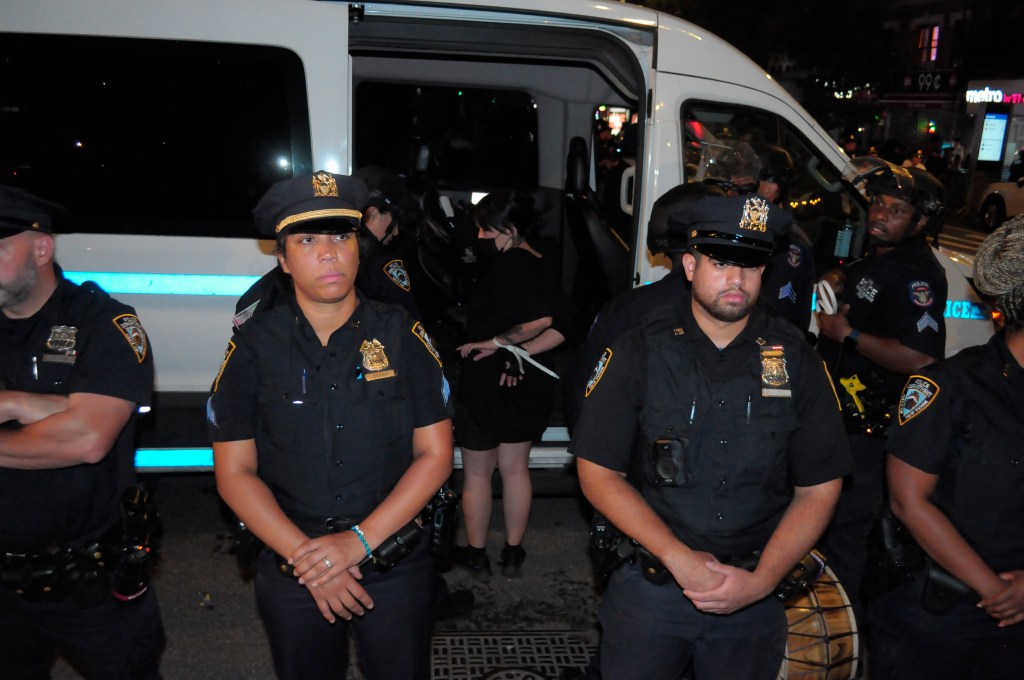 An anti-Israel protesters getting taken into police custody. 