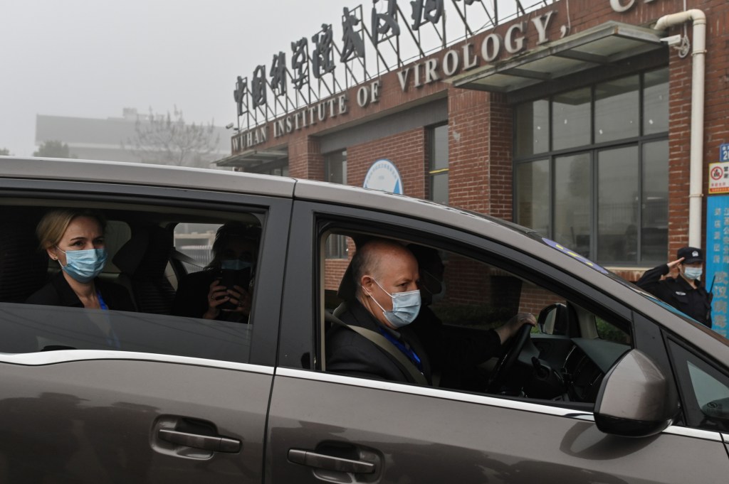 Peter Daszak (R), Thea Fischer (L) and other members of the World Health Organization (WHO) team investigating the origins of the COVID-19 coronavirus, arrive at the Wuhan Institute of Virology in Wuhan in China's central Hubei province on February 3, 2021.