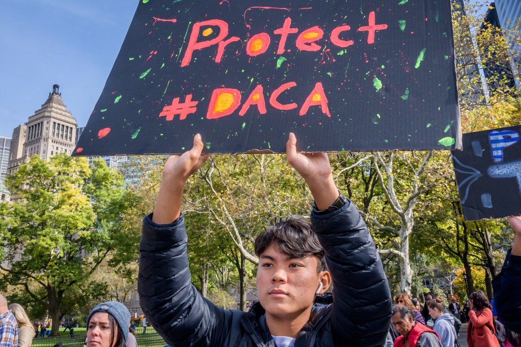 Participant holding a sign at an immigration rally in Manhattan, New York