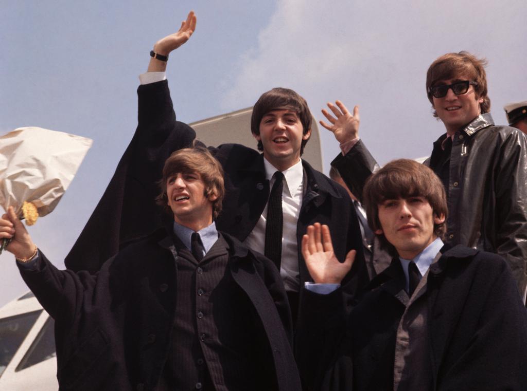 A photo of the Beatles on their arrival in London  following a tour of Australia in 1964.