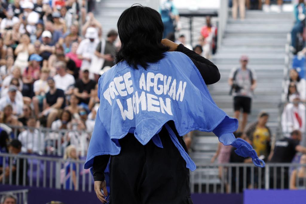 Refugee Olympic team's Manizha Talash, known as Manizha wears a jacket reading "Free Afghan women" as she competes in the Women's Breaking dance qualifying round of the Paris 2024 Olympic Games at La Concorde in Paris, on August 9, 2024.