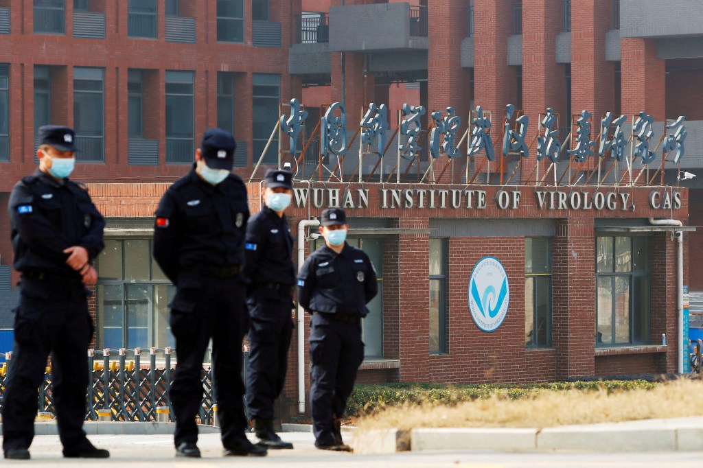 Security personnel keep watch outside Wuhan Institute of Virology during the visit by the World Health Organization (WHO)  team tasked with investigating the origins of the coronavirus disease (COVID-19), in Wuhan, Hubei province, China February 3, 2021.