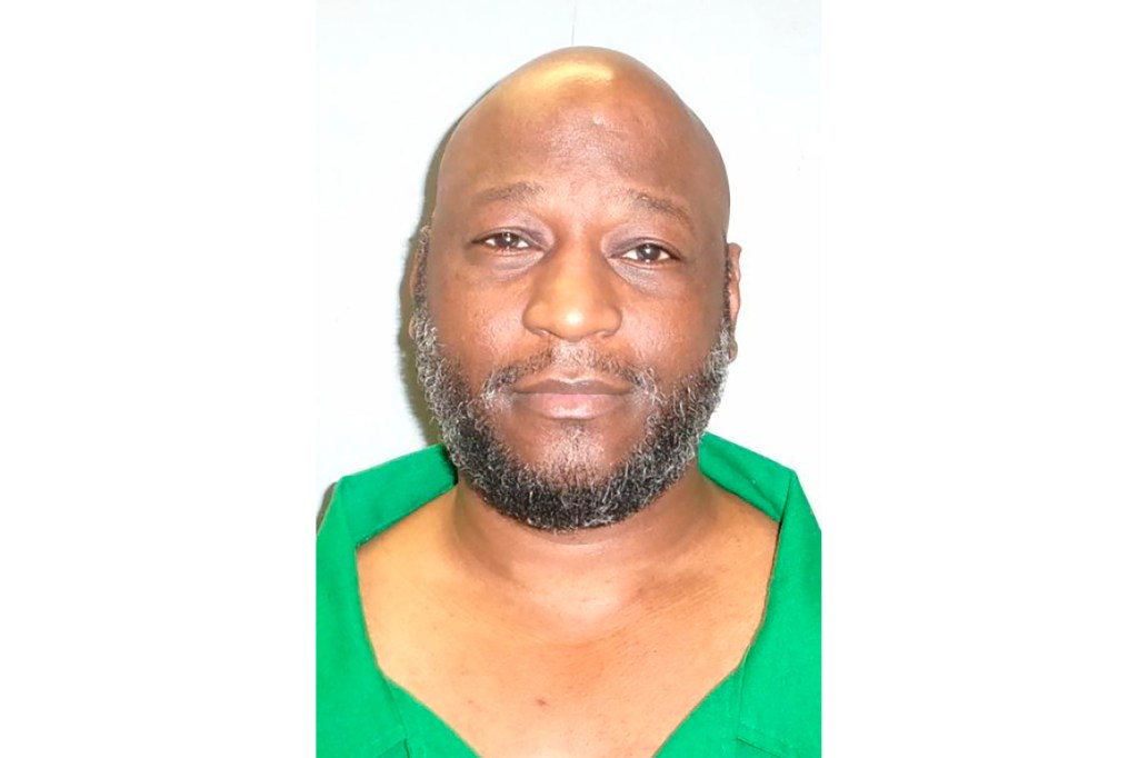 Freddie Eugene Owens mugshot, seen with beard and wearing green prison clothes