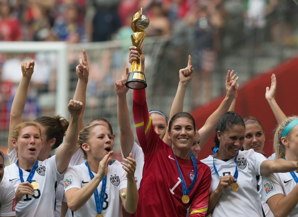 United States goalkeeper Hope Solo hoists the trophy as she and her teammates celebrate defeating Japan to win the FIFA Women's World Cup soccer championship in Vancouver, British Columbia, Canada, Sunday, July 5, 2015.    