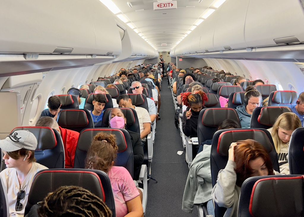 Passengers sit on board an airplane as they travel from Charlotte, North Carolina, to Washintgon, DC