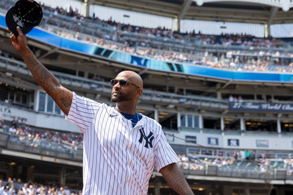 CC Sabathia salutes fans as he walks out to the field for introductions during Old Timer's Day before a game against the Colorado Rockies, Saturday, Aug. 24, 2024