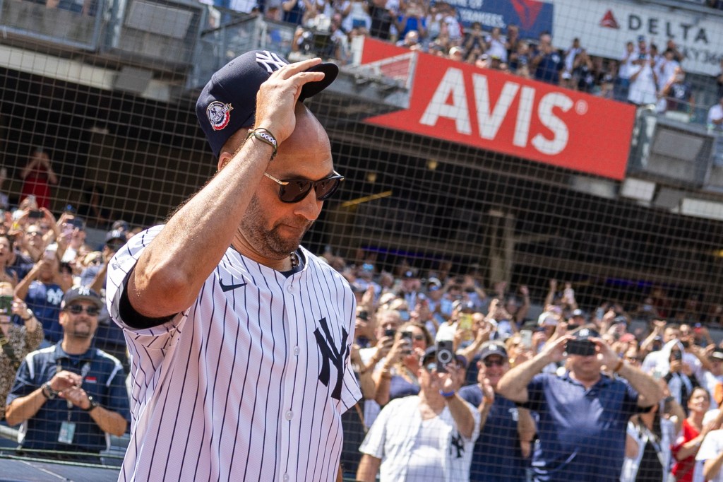 Yankees Derek Jeter salutes fans as he walks out to the field for introductions during Old Timer's Day before a game against the Colorado Rockies, Saturday, Aug. 24.