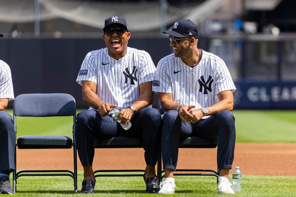 Yankees greats Mariano Rivera and Derek Jeter are all laughs as they sit on the field during Old Timers' Day before a game against the Colorado Rockies, Saturday, Aug. 24, 2024