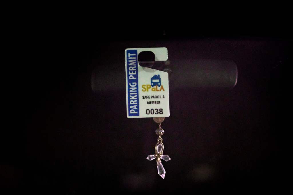 A Safe Parking LA parking permit is seen in a car windshield.