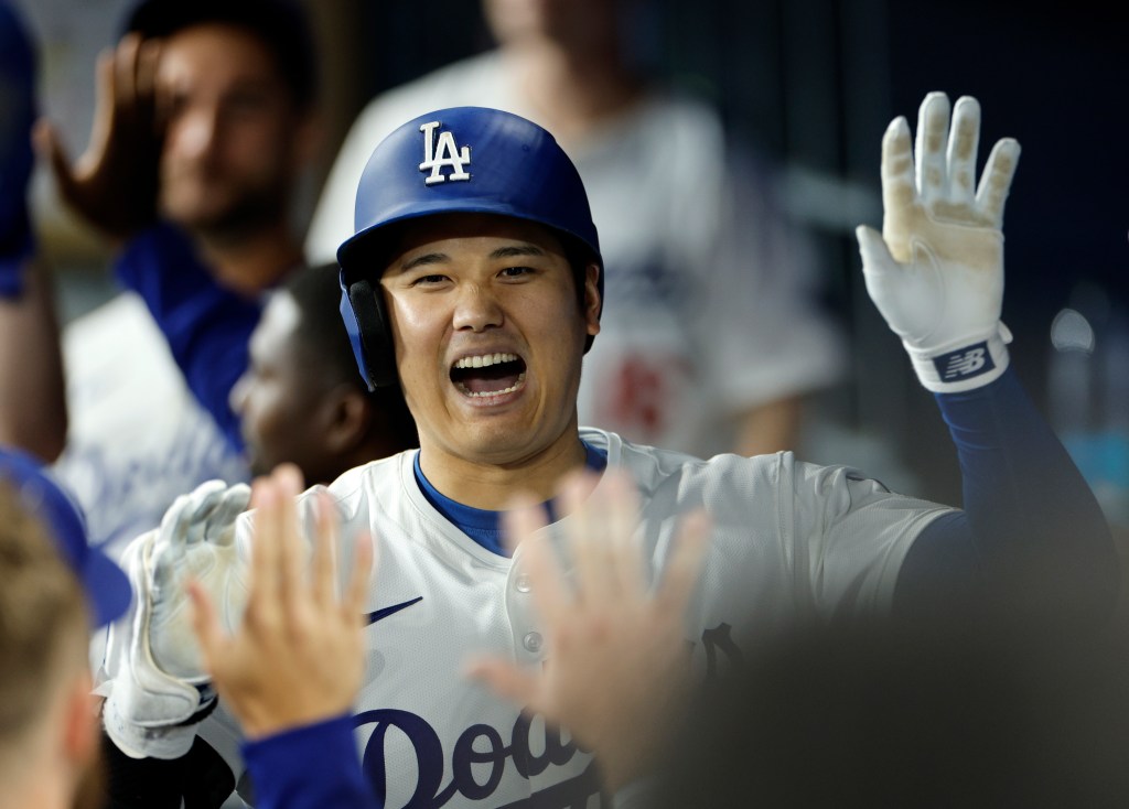 Designated hitter Shohei Ohtani of the Los Angeles Dodgers celebrates in the dugout after hitting his 52nd career home run during the fifth inning on Sept. 20.