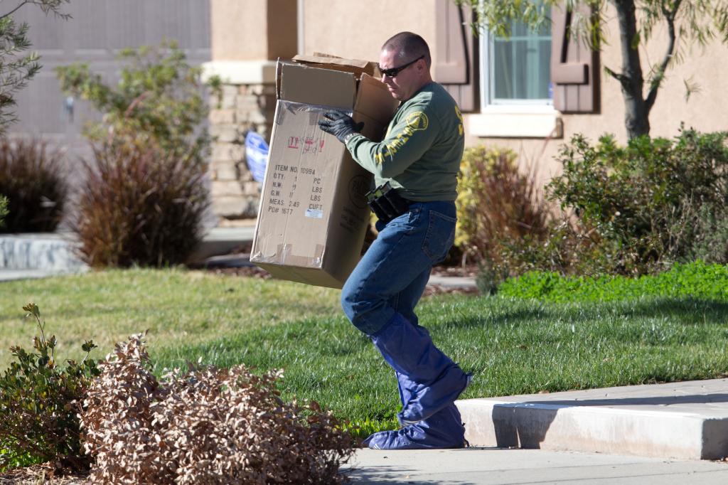 A sheriff removing evidence from the Turpin family home in 2018.