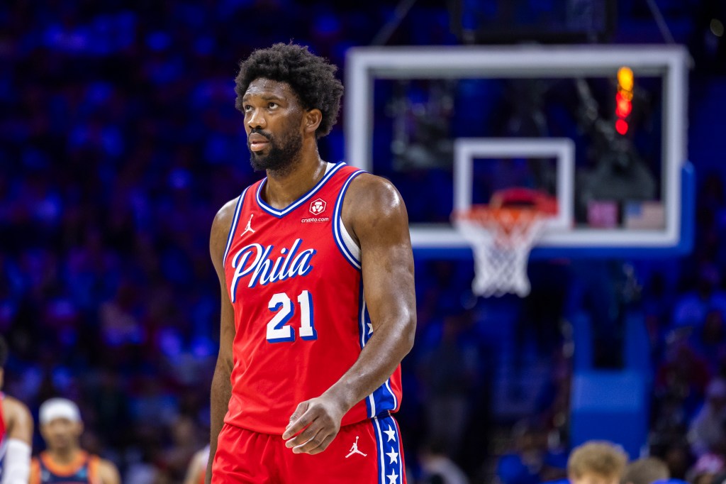 Joel Embiid #21 of the Philadelphia 76ers in red uniform, reacting on court during game 4 of Eastern Conference first round