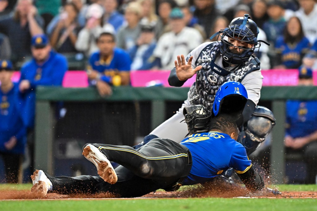 Victor Robles of the Seattle Mariners caught stealing home plate by Austin Wells of the New York Yankees during a baseball game at T-Mobile Park, Seattle