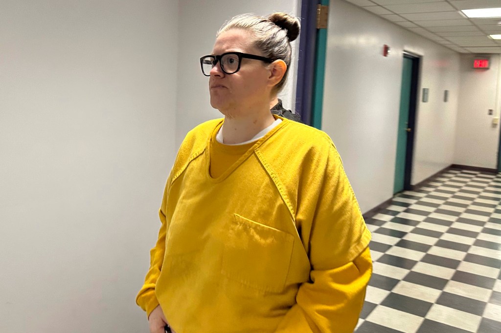 Lisa Snyder in yellow shirt being led into Berks County Court, Reading, PA, for her court appearance regarding the murder of her two young children.