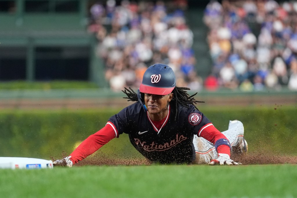 Washington Nationals' CJ Abrams steals third base during the first inning of a baseball game against the Chicago Cubs, Thursday, Sept. 19, 2024, in Chicago. 