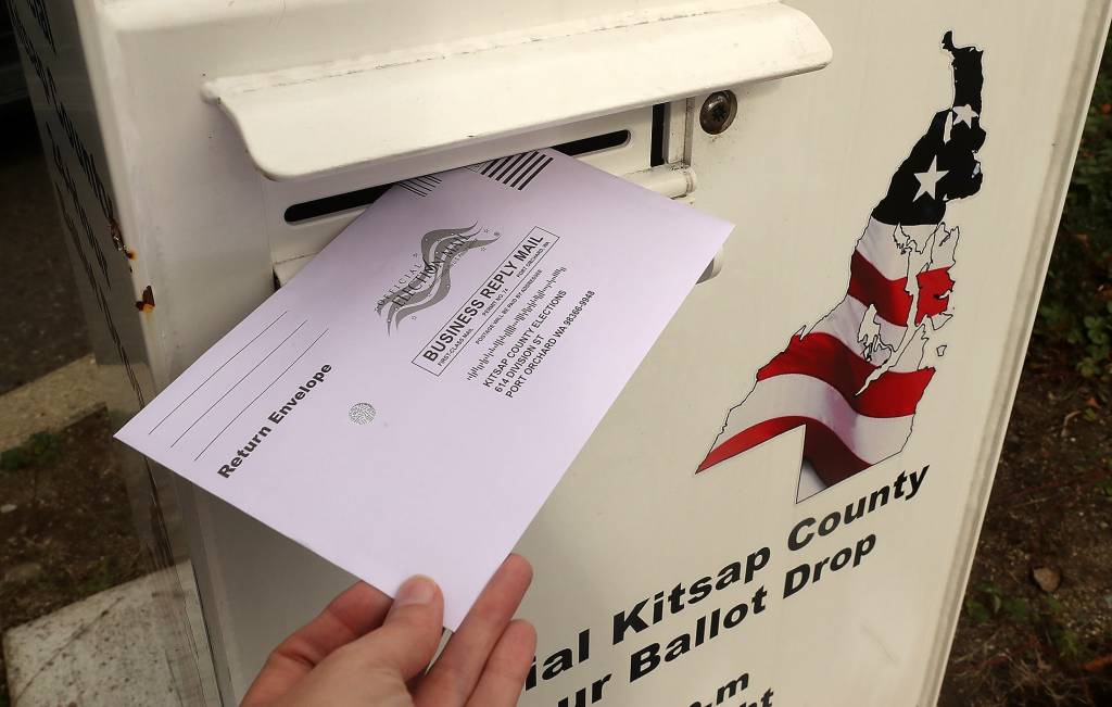 A ballot is dropped into the box at the Norm Dicks Government Center in Bremerton 