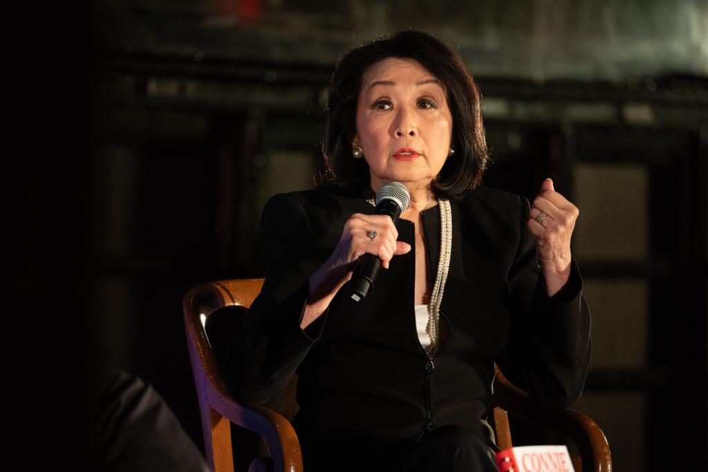 Connie Chung holding a microphone at the New York Public Library, discussing her memoir during the 'LIVE From NYPL' event on September 17, 2024.