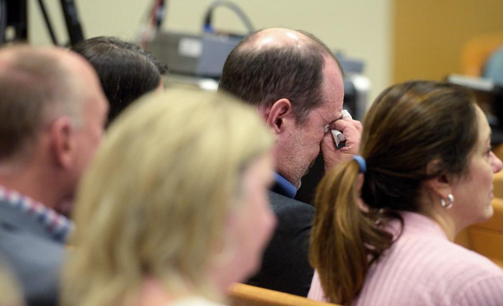 David Wheeler wipes away tears as attorney Chris Mattei shows a photograph of his family, including son Ben, during his closing statements in the Alex Jones Sandy Hook defamation damages trial in Superior Court in Waterbury, Connecticut, U.S., on October 6, 2022.