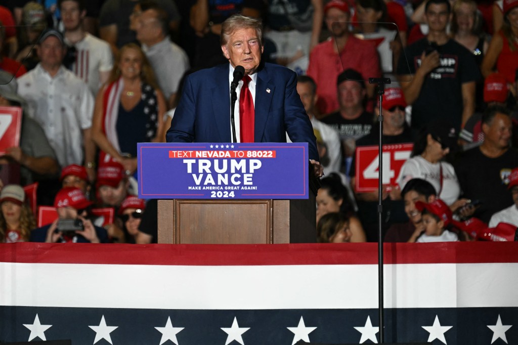 Former President Donald Trump speaking at a campaign rally podium in Las Vegas, Nevada on September 13, 2024