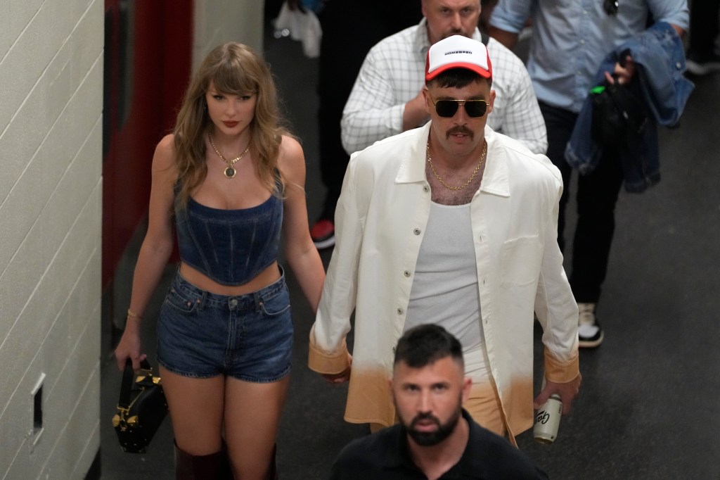 Taylor Swift and Travis Kelce hold hands following the Chiefs' win on Sept. 5, 2024.