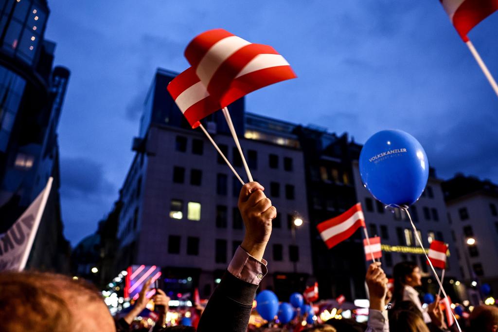 Freedom Party supporters waving flags at a rally in Vienna on Sept. 27, 2024.