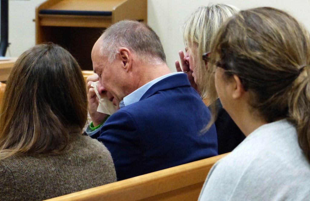 Mark Barden wipes away tears after his testimony during the Alex Jones Sandy Hook defamation damages trial at Connecticut Superior Court in Waterbury, Conn., Tuesday, Oct. 4, 2022. 