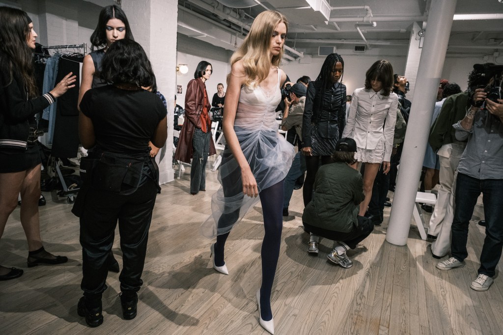 a model at the Private Policy fashion show in Manhattan, wearing a white dress, with the collection inspired by Americana and New York.