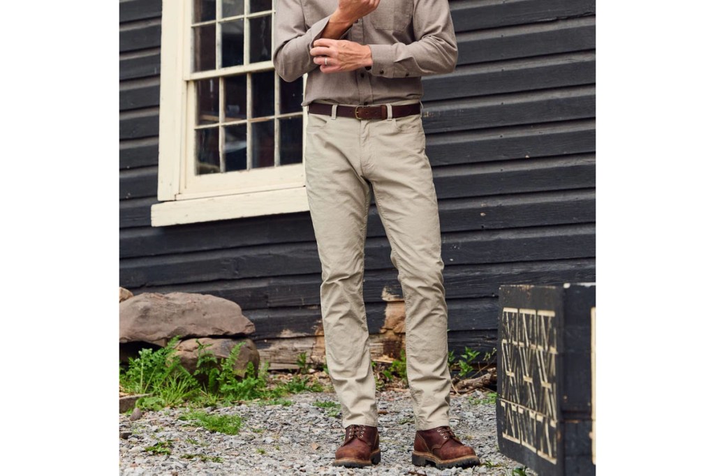 A man wearing khaki pants and brown shoes