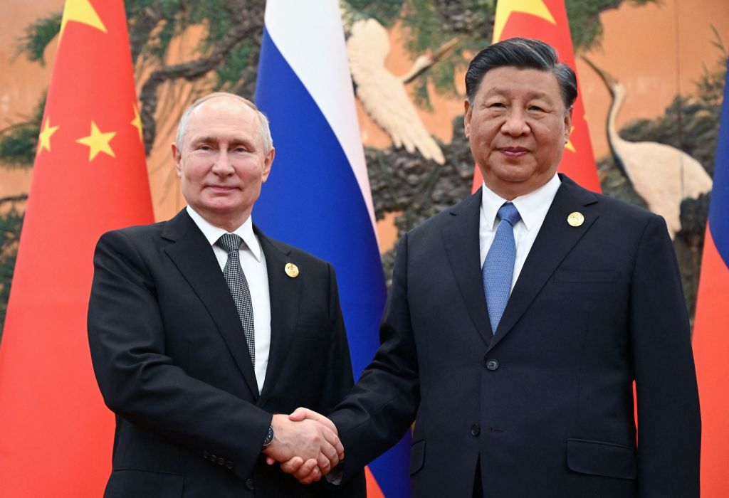 Russian President Vladimir Putin and Chinese President Xi Jinping shaking hands during a meeting in Beijing