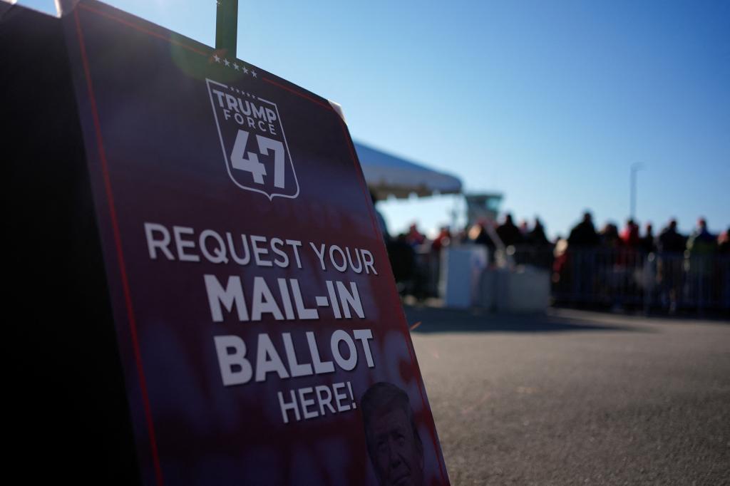 A Trump Force 47 sign that reads "REQUEST YOUR MAIL-IN BALLOT HERE!"