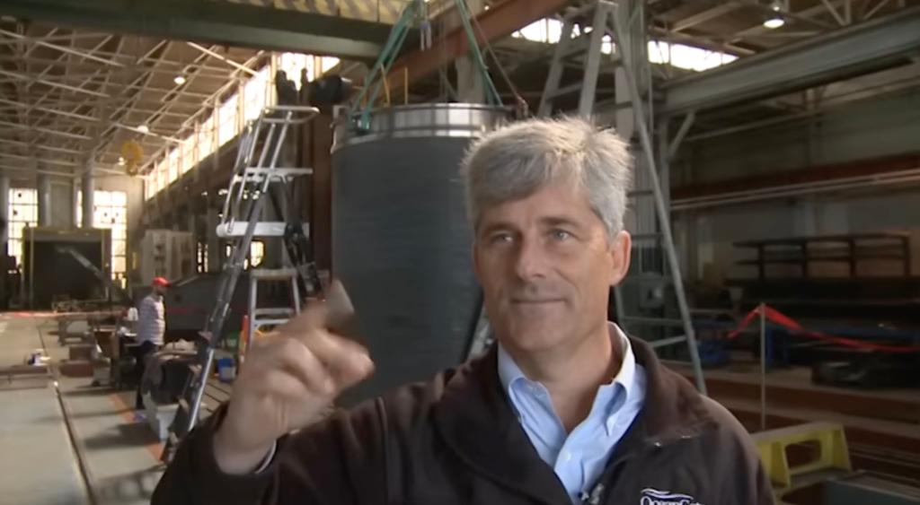 Stockton Rush, CEO of OceanGate Expeditions, in a factory setting discussing the construction of a submarine