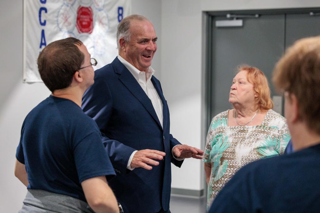 U.S. Rep Dan Kildee mingling with supporters at Kristen McDonald Rivet's campaign watch party on August 6, 2024, in Saginaw, Michigan