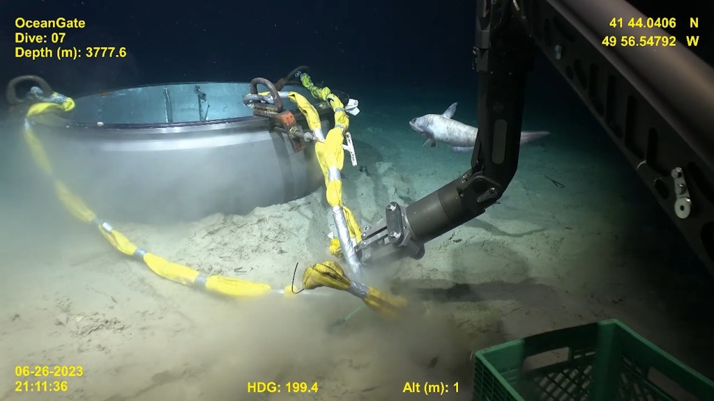 Remotely operated vehicle on ocean floor recovering parts of the Titan submersible for the US Coast Guard's investigation of a deadly implosion