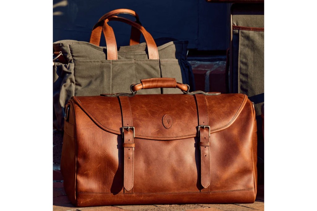 A brown leather bag next to another brown bag