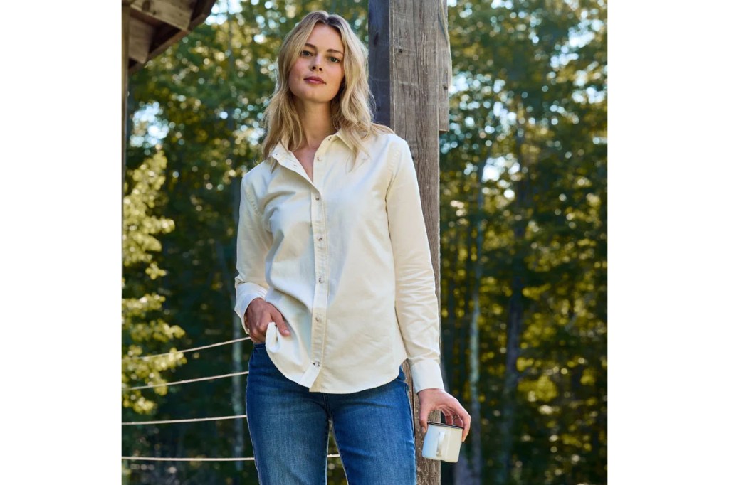 A woman standing outside holding a cup